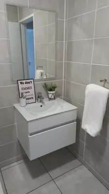 a bathroom with a white sink and a mirror at The Blyde resort in Pretoria