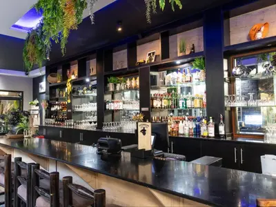 a bar with a lot of bottles of alcohol at Eco Lodge Lephalale in Lephalale