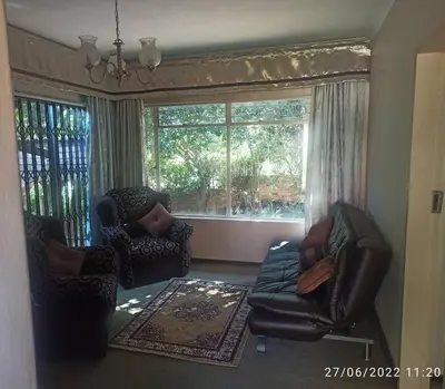 a living room with two chairs and a couch at CHEZ BRUNO in Pretoria