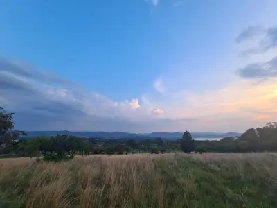 a field of tall grass with the sky in the background at Mountain Villa House in Hartbeespoort