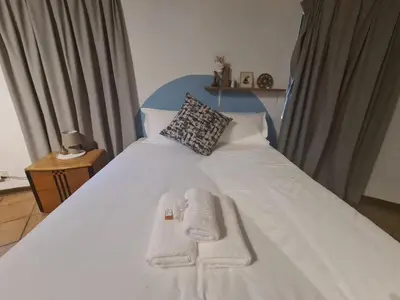 a bedroom with a bed with two towels on it at Mountain Villa House in Hartbeespoort