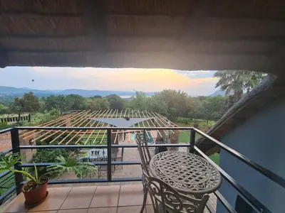 a balcony with a table and chairs and a view at Mountain Villa House in Hartbeespoort