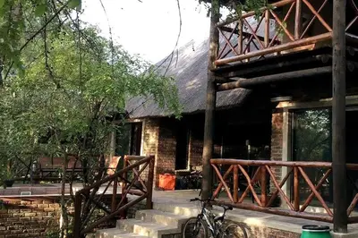 a bike parked in front of a brick house at Amani Milele (Everlasting Peace) in Marloth Park