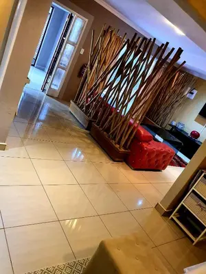 a living room with a bunch of wood sticks at MAKWATAMBANI GUEST MANOR in Thohoyandou