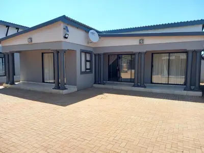 a house with a brick driveway in front of it at R&R GUEST HOUSE in Lenyenye