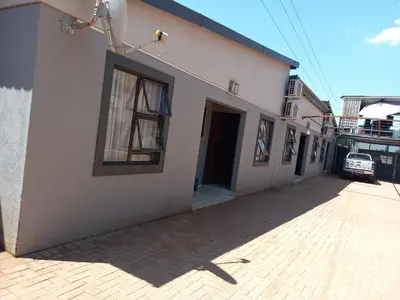 a building with a window on the side of it at R&R GUEST HOUSE in Lenyenye