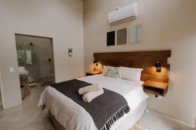 a bedroom with a bed with a towel on it at Afri Villa Stays - Luxury Bush Villa Hyena in Marloth Park