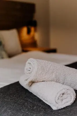 a white towel sitting on top of a bed at Afri Villa Stays - Luxury Bush Villa Hyena in Marloth Park