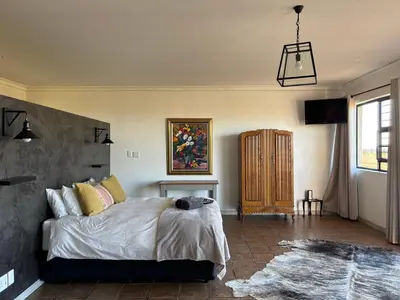 a bedroom with a bed in a room with a window at Dewdrop Farm Stay in Ermelo