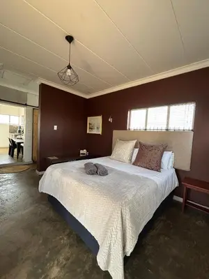 a bedroom with a large bed in a room at Dewdrop Farm Stay in Ermelo