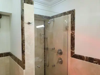 a shower with a glass door in a bathroom at Spacious Golf & Wildlife Estate in Hartbeespoort 10 sleeper in Hartbeespoort