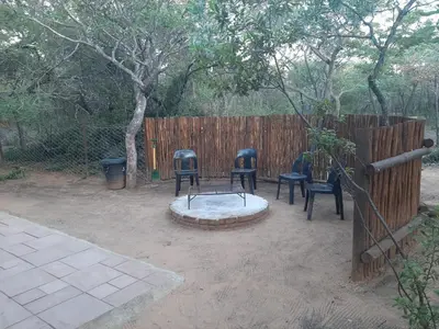 a group of chairs sitting next to a fence at VlakkiesKraal Bosbok Camp in Bela-Bela