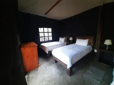 a bedroom with two beds and a window at VlakkiesKraal Bosbok Camp in Bela-Bela