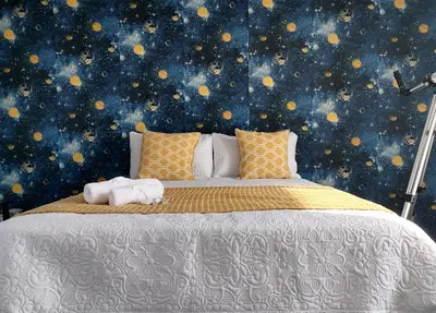 a bedroom with a large bed with a space wall at Drakensview guesthouse in Acornhoek