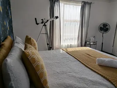 a bedroom with a bed with a camera on a tripod at Drakensview guesthouse in Acornhoek