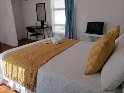 a bedroom with a bed with two towels on it at Drakensview guesthouse in Acornhoek