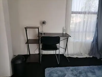 a desk with a chair in a room with a window at Drakensview guesthouse in Acornhoek