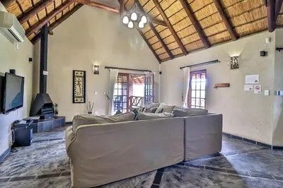 a large living room with a couch and a tv at Kruger Escape - Solar System in Marloth Park