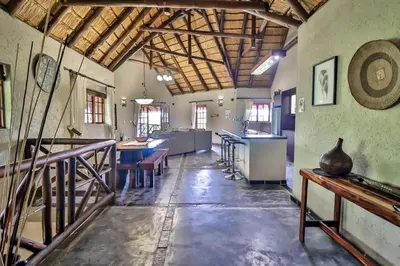 a large room with a kitchen and a dining room at Kruger Escape - Solar System in Marloth Park