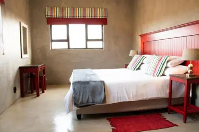 a bedroom with a large bed and a window at The Barnhouse in Hammanskraal
