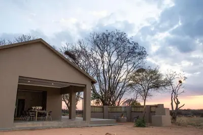 a small house with a table and a fence at The Barnhouse in Hammanskraal