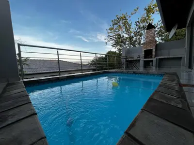 a swimming pool on the side of a house at Moya-Sky in Komatipoort
