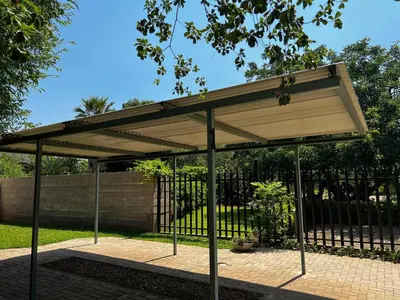 a pavilion with awning in front of a fence at Moya-Sky in Komatipoort