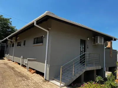 a gray building with a staircase on the side of it at Moya-Sky in Komatipoort