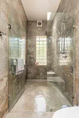 a bathroom with a glass shower and a sink at House Firefly Muckleneuk - Furnished House in Pretoria