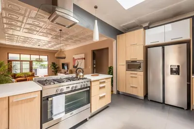a kitchen with a stove and a refrigerator at House Firefly Muckleneuk - Furnished House in Pretoria