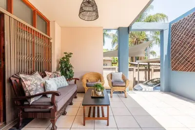 a living room with a couch and chairs on a porch at House Firefly Muckleneuk - Furnished House in Pretoria