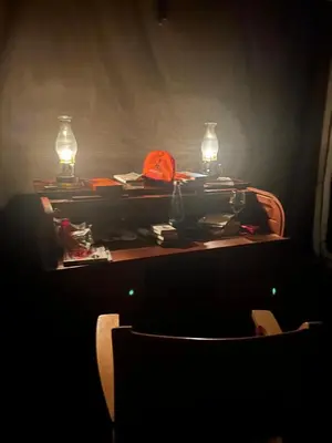 a table with two lights and a chair in a dark room at Out in Africa Wildlife Lodge in Dinokeng Game Reserve