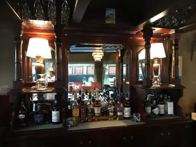 a bar with a lot of bottles of alcohol at Out in Africa Wildlife Lodge in Dinokeng Game Reserve