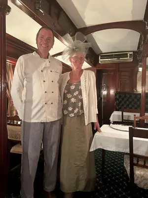 a man and a woman standing next to a bed at Out in Africa Wildlife Lodge in Dinokeng Game Reserve