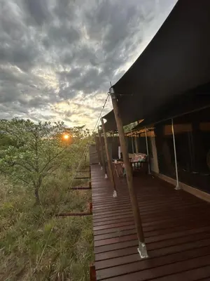 a porch of a house with a sunset in the background at Out in Africa Wildlife Lodge in Dinokeng Game Reserve