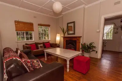 a living room with a couch and a table at Climber's house in Waterval Boven