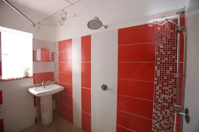 a red and white bathroom with a sink and a shower at Climber's house in Waterval Boven