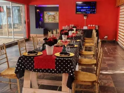 a long dining room with a long table and chairs at Tee Cee Marvelous Guesthouse in Thabazimbi