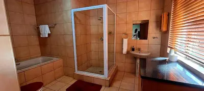 a bathroom with a shower and a sink at Tee Cee Marvelous Guesthouse in Thabazimbi
