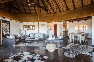 a living room with a zebra rug on the floor at Magari Safari Villa in Vaalwater