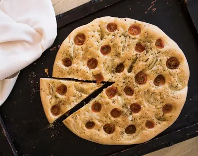 a large pizza sitting on top of a table at Magari Safari Villa in Vaalwater