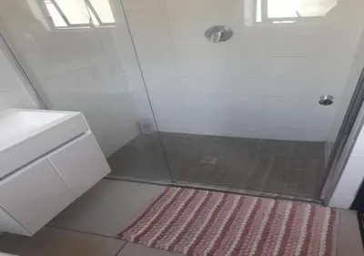 a bathroom with a shower with a glass door at Neat Appartment, Fourways in Midrand