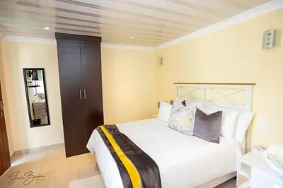 a bedroom with a large bed in a room at Zoe BnB in Midrand