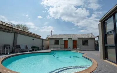 a swimming pool in front of a house at Zoe BnB in Midrand