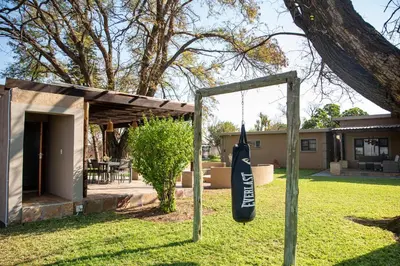 a bag hanging from a swing in a yard at Origon Farmhouse in Brits