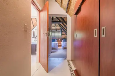 a hallway with a door leading to a dining room at Kruger Park Lodge Unit No. 241 in Hazyview