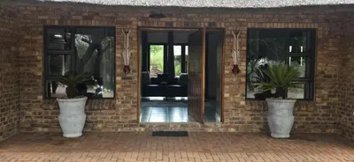 a brick wall with two vases with plants in them at Makhato Bush Lodge 48 in Bela-Bela