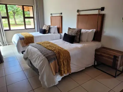 two beds in a hotel room at Makhato Bush Lodge 48 in Bela-Bela