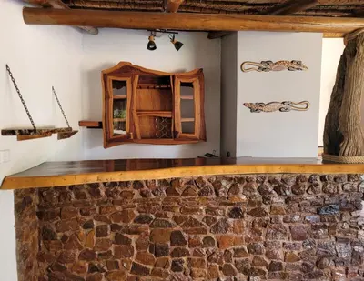 a room with a stone wall and a mirror at Makhato Bush Lodge 48 in Bela-Bela