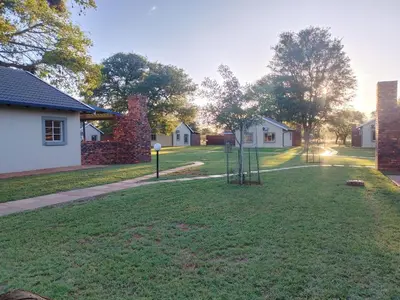 a yard with a swing set in the grass at Mukumbura Swartwater in Swartwater